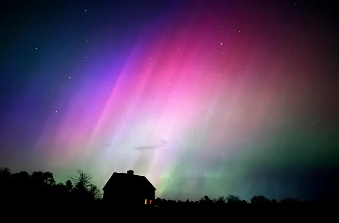 Solar storm causing auroras over a darkened Earth